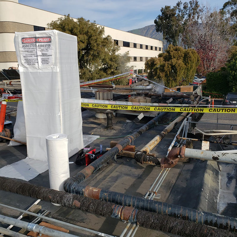 Quality Environmental Inc. performing asbestos abatement on a hospital roof Image 2